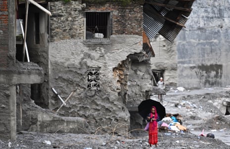 A woman walks among the ruins of flash floods in Nepal's Nuwakot district on 1 September 2026.