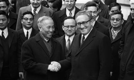 Henry Kissinger shakes hand with Le Duc Tho, leader of the North Vietnam delegation, after the signing of peace accords on 23 January 1973 in Paris.