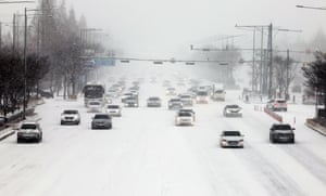Cars move cautiously after heavy snowfall in Gwangju, South Korea