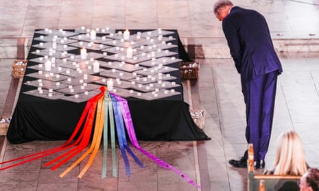 Norwegian prime minister, Jonas Gahr Støre, lights a candle at the memorial service at Oslo Cathedral.