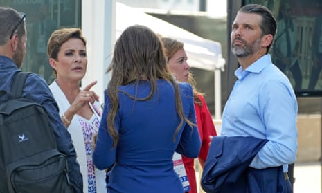 Kari Lake, second from left, talks to group including Donald Trump Jr, outside the Fiserv Forum in Milwaukee.