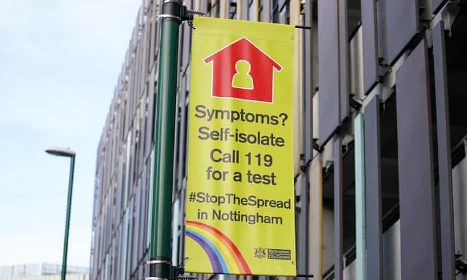 A sign in Nottingham reads 'Symptoms? Self-isolate, call 119 for a test'