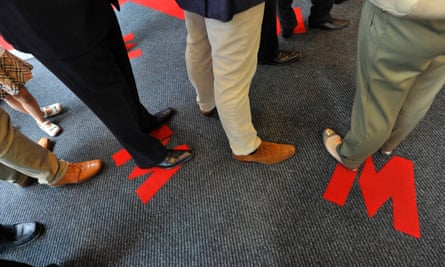 Closeup of customers’ feet as they queue at a branch of Metro Bank