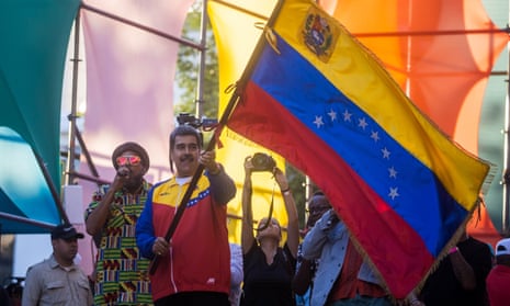 Nicolás Maduro the president of Venezuela, waves a Venezuelan flag in Caracas