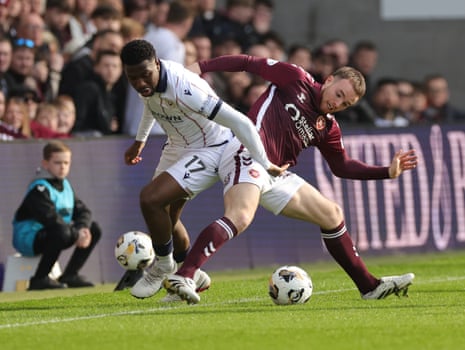 Dundee United’s Tony Yogane (left) and Heart of Midlothian’s Marc Leonard battle for the ball.