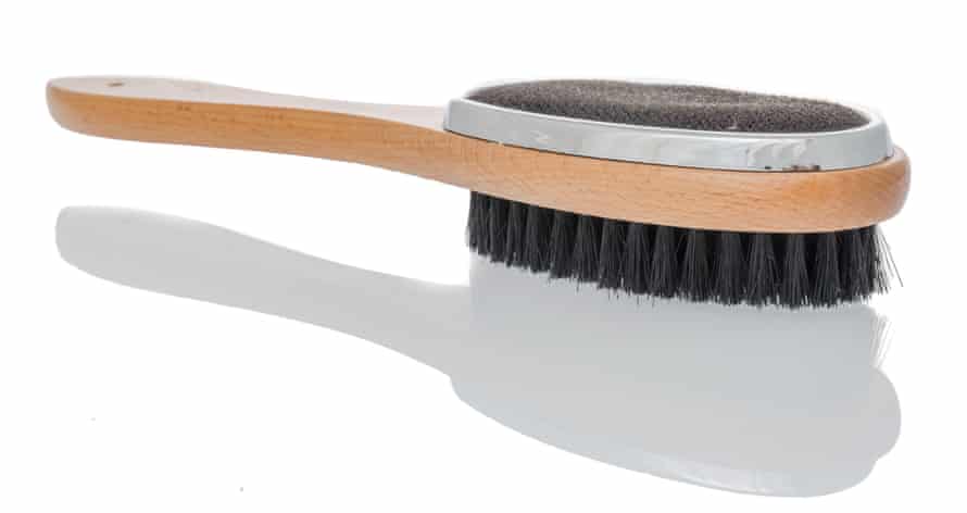 A clothes brush and lint remover brush combination on an isolated background
