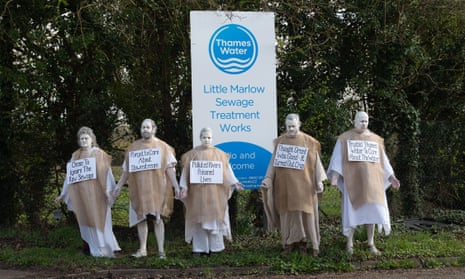 Extinction Rebellion members dressed as penitents protest against Thames Water in Little Marlow, Buckinghamshire.