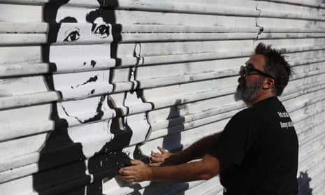 Manuel Oliver, who lives in Florida and is the father of slain high school student Joaquin Oliver, works on a painting on the US border wall in Tijuana, Mexico, that will carry the Spanish message: ‘On the other side they also kill our children.’