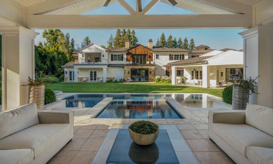 View of the interior, with sofas looking out on to a pool.