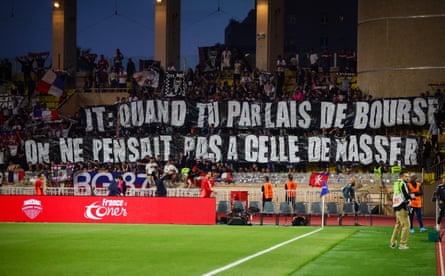 Lyon fans hold up a banner criticising the club’s owner John Textor.