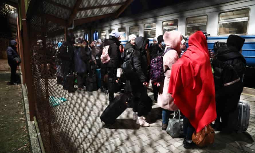 People fleeing from Ukraine arrive at the train station in Przemysl, Poland on Wednesday.