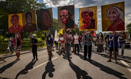 Climate activists hold up portraits of killed Philippine environmental defenders during a climate justice protest last November.