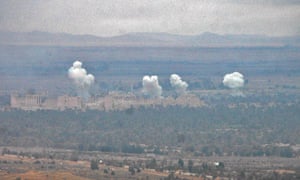 Smoke billows as Syrian regime fighters advance to retake the ancient city of Palmyra from Isis.