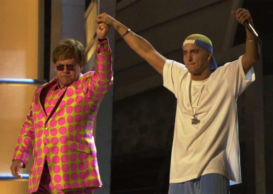 Elton John and Eminem share the stage following their duet at the 43rd annual Grammy Awards