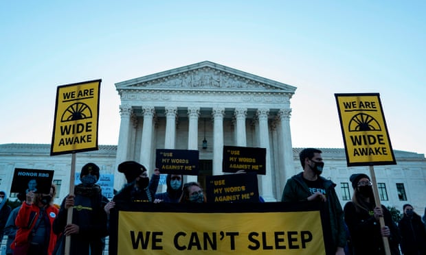 Protesters outside the supreme court on Monday. Ginsburg is expected to lie in state at the court before a funeral at Arlington National Cemetery.