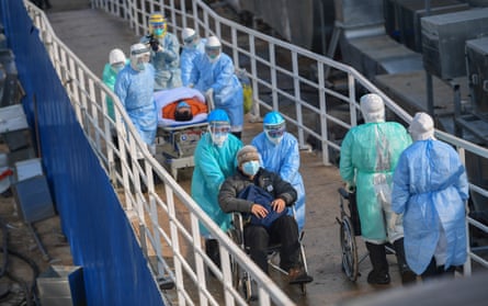 Medical staff transfer patients to the newly completed Huoshenshan temporary field hospital on 4 February 2020.