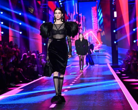 A model on the catwalk in exaggerated black dress