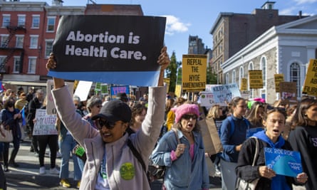 A protester holds a sign that reads ‘abortion Is healthcare’ during a march in New York City in October 2022.