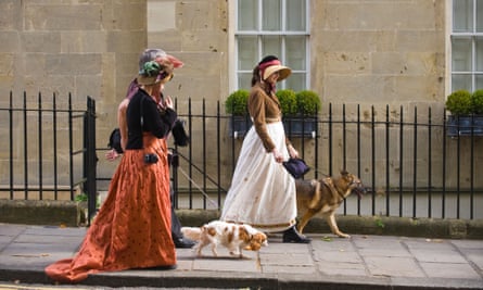 Two women in Regency costume walking dogs through Bath city centre during the 2012 Jane Austen FestivalCXBBGY Two women in Regency costume walking dogs through Bath city centre during the 2012 Jane Austen Festival