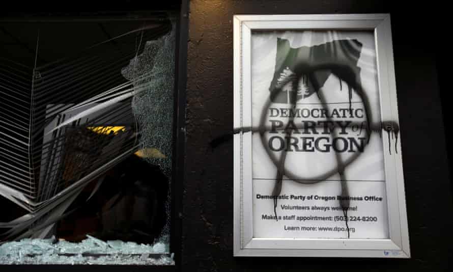A smashed window and anarchist symbol spray-painted on the building in Portland, Oregon, on 20 January.