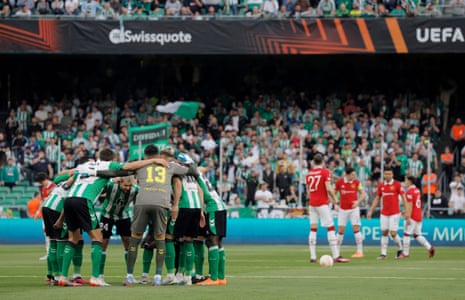 The players huddle before kick-off.