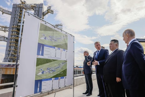 Vladimir Putin andKim Jong-un study an information display at the Vostochny cosmodrome.