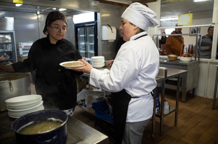 Cooks Katherine Arlos Buerra, in white, and Nicole Droguett Pina.