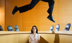 Businesswoman Watching Leaping Businessman<br>EE5K6T Businesswoman Watching Leaping Businessman