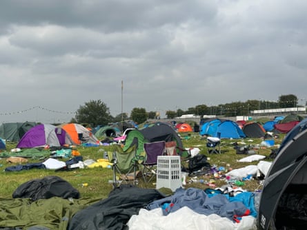 A field filled with abandoned tents and camping chairs