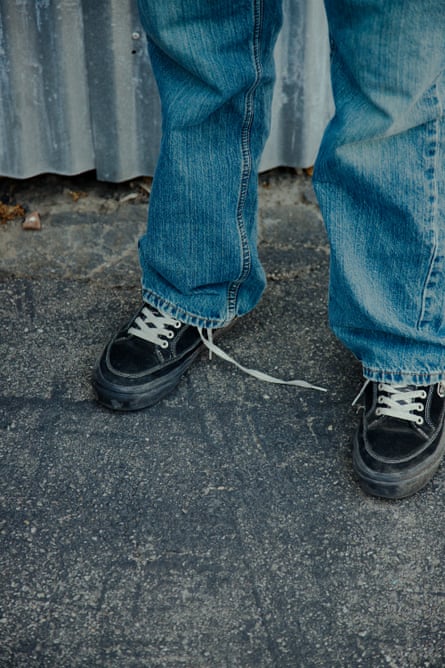 A detail of Eli’s untied sneakers