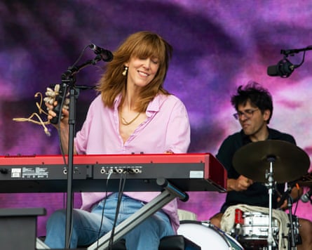 Orton in a lilac shirt and jeans performing