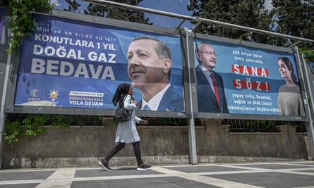 A woman walks past billboards featuring the election rivals Erdoğan and Kılıçdaroğlu in Şanlıurfa, south-east Turkey.