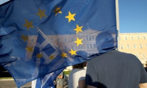 Demonstrators rally in front of the Greek parliament with Greek and EU flags