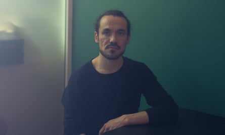 Portrait of man with green wall behind