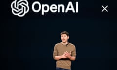 A man speaks in front of a black screen with