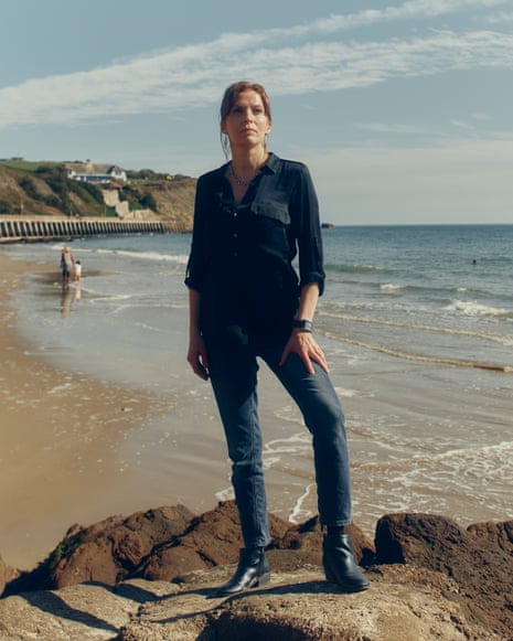 Woman wearing black shirt and jeans standing on rocks at the beach in photographed in Folkestone, September 23 2026