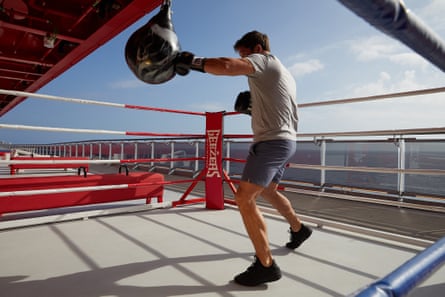 A man boxes on the Scarlet Lady