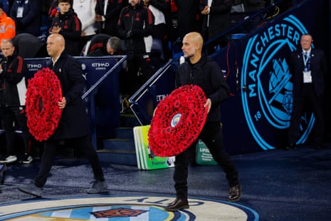 Arne Slot and Pep Guardiola carry wreathes before kick-off.