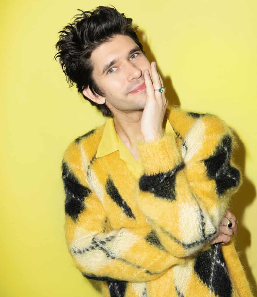 Head shot of actor Ben Whishaw in yellow shirt and cardigan against yellow background, January 2022
