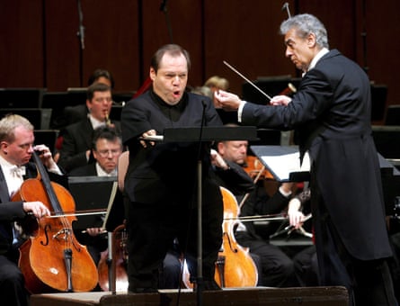 Placido Domingo conducts as Quasthoff sings during dress rehearsals of the inauguration concert to mark the opening of the Theater an der Wien in Vienna in 2005.