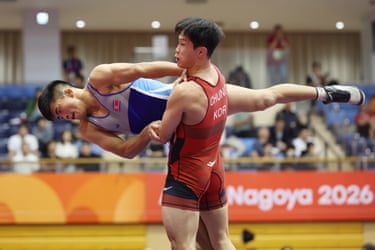 Chung Han-jae and Son Man-gwang compete in a wrestling match