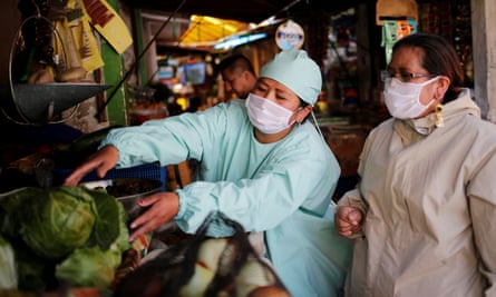 Reina and Cecilia Gutierrez, wearing protective clothing, are seen at a market amid the coronavirus outbreak in La Paz, Bolivia, this month.