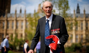 Joachim Roenneberg holds a Union flag presented to him at the House of Lords in 2013.