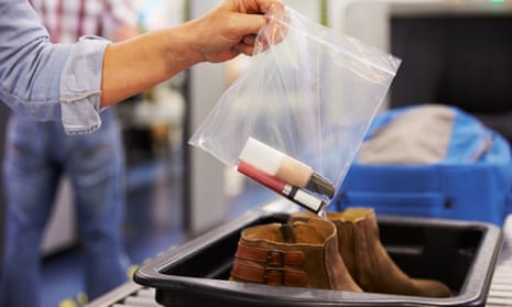 Passenger Puts Liquids Into Bag At Airport Security Check