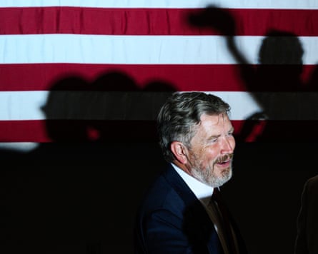 Thomas Massie stands next to a US flag