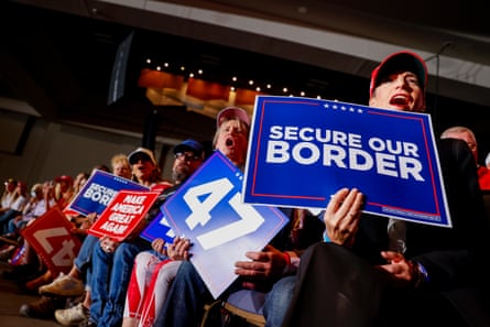 people holding red and blue signs cheer