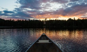 The bow of a canoe on Lang Pond in Maine's Northern Forest.