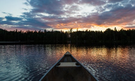 The bow of a canoe on Lang Pond in Maine’s Northern Forest.