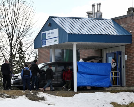 People work at the high school where a deadly mass shooting took place, in the town of Tumbler Ridge, British Columbia, Canada.