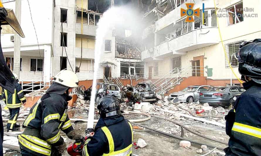 Emergency service workers rescue people after a missile strike, as Russia’s invasion of Ukraine continues, in Odesa Oblast.